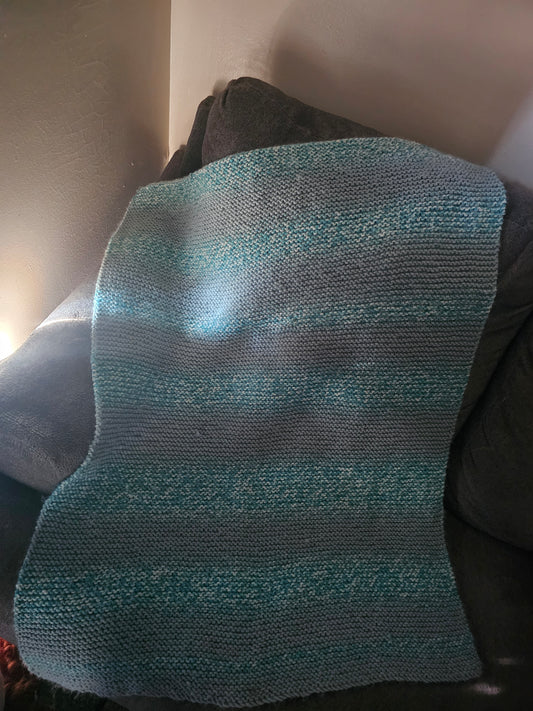 Hand knitted blue lap blanket