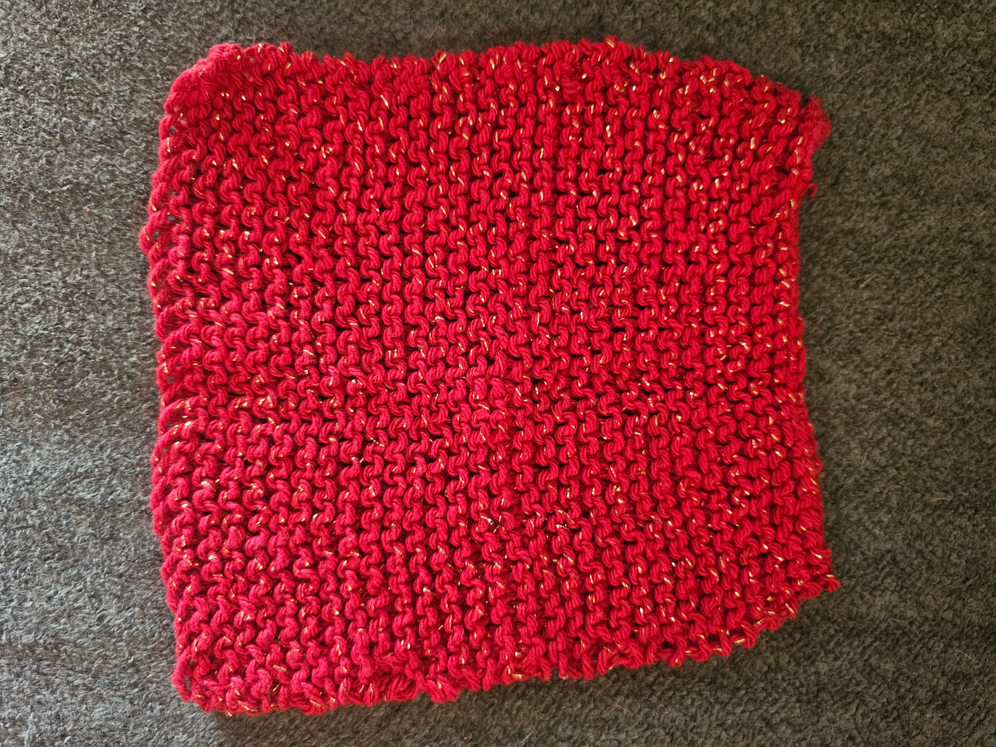 Hand knitted washcloth with gold accents